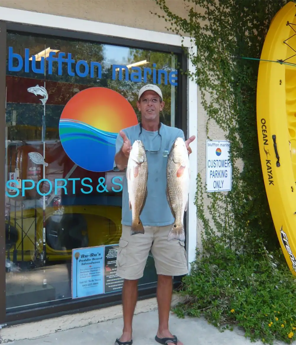 man holding freshly caught fish
